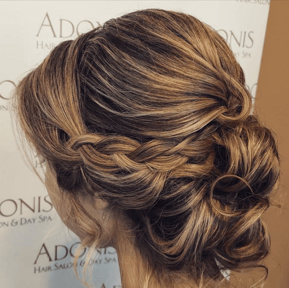 Elegant braided updo hairstyle showcased at Adonis Hair Salon and Day Spa.